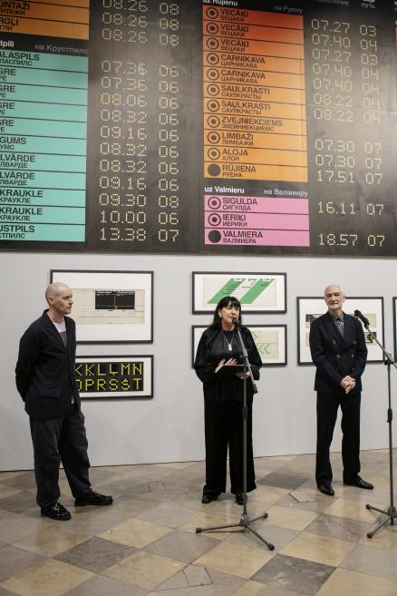 Exhibition team at the station's signboard wall.