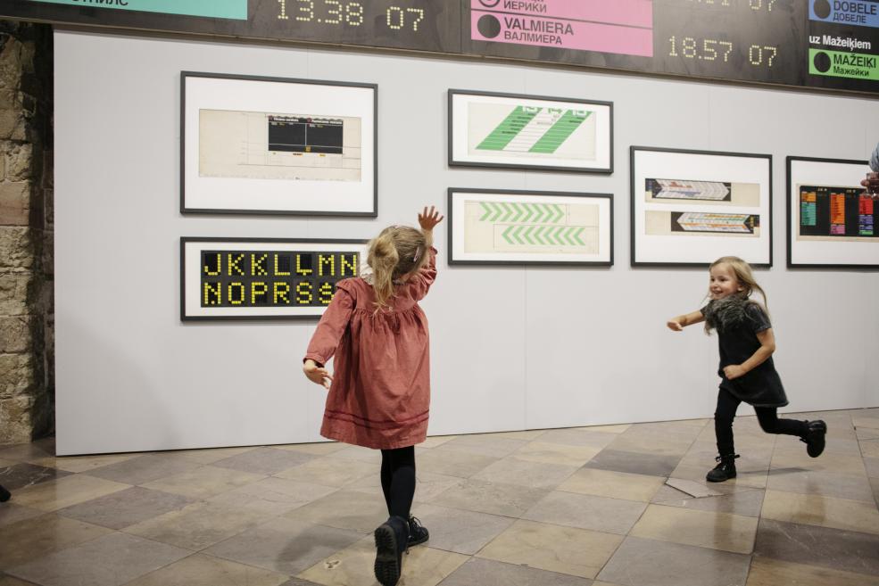 A little girl dances in the exhibition hall.