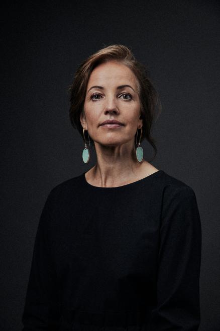A woman with turquoise earrings