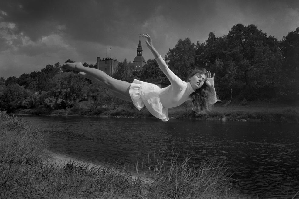 Black and white photo of a flying girl.