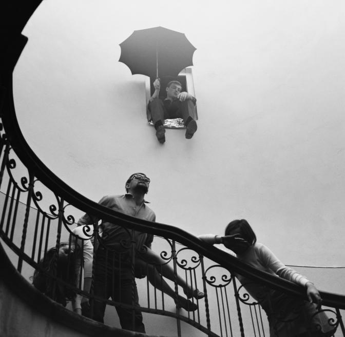 Black and white photo of people in a stairwell.