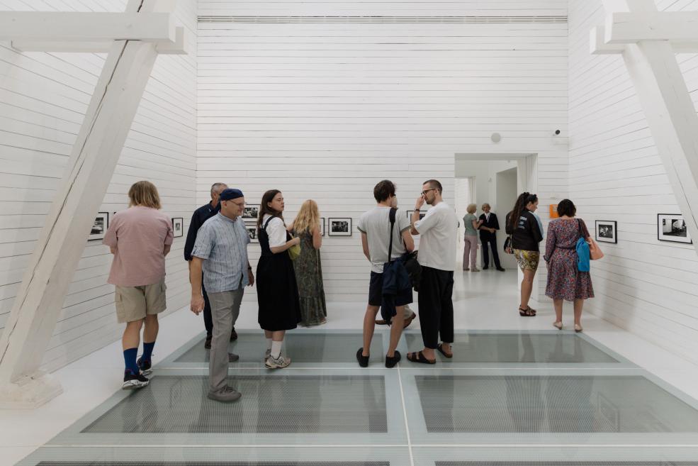 Visitors view the works at the opening of the exhibition.