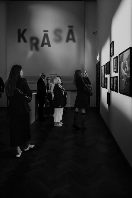 Black and white image with visitors at the opening of the exhibition.