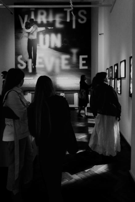 Black and white image with visitors at the opening of the exhibition.