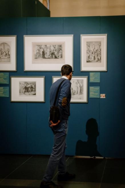 A visitor looks at the works of art in the exhibition.